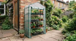 A sturdy 4-tier mini greenhouse with a reinforced PVC cover, designed to protect plants from British weather.