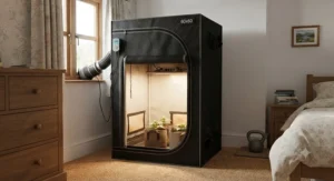 A discreet small-space indoor grow tent measuring 60x60cm positioned neatly in a British bedroom corner.