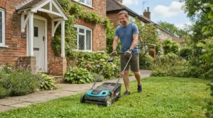An easy-to-manoeuvre lawn mower for small gardens tackling a compact front garden lawn near a brick wall